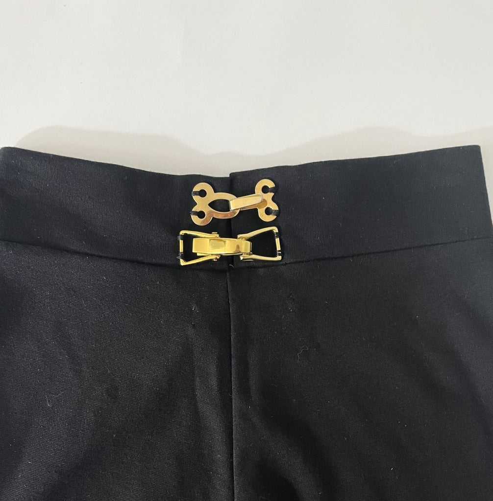 Handmade black asymmetrical ruffle leggings, size XS, with two gold metal closures at the back, crafted from synthetic double-knit by Sarah Aphrodite.
