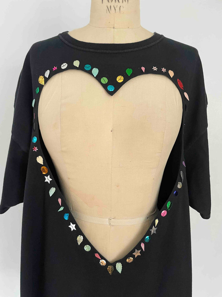 One-of-a-kind black upcycled cotton T-shirt with large heart cut-out and handsewn assorted sequins by Sarah Aphrodite, oversized XL fit