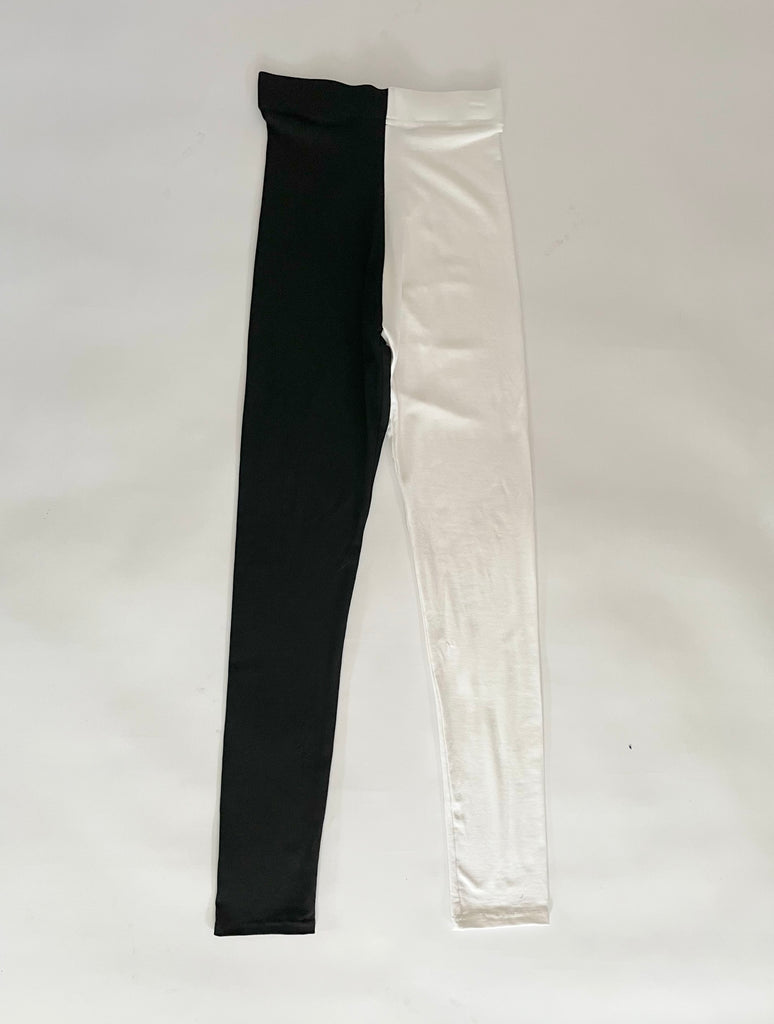 One-of-a-kind handmade high-waisted black and white leggings by Sarah Aphrodite, crafted from sustainable deadstock and gifted jersey fabrics, designed for comfort and expressive eco-conscious style.