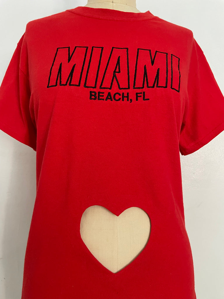 Red repurposed T-shirt with heart cut-out and Miami Beach FL embroidery, displayed on mannequin.