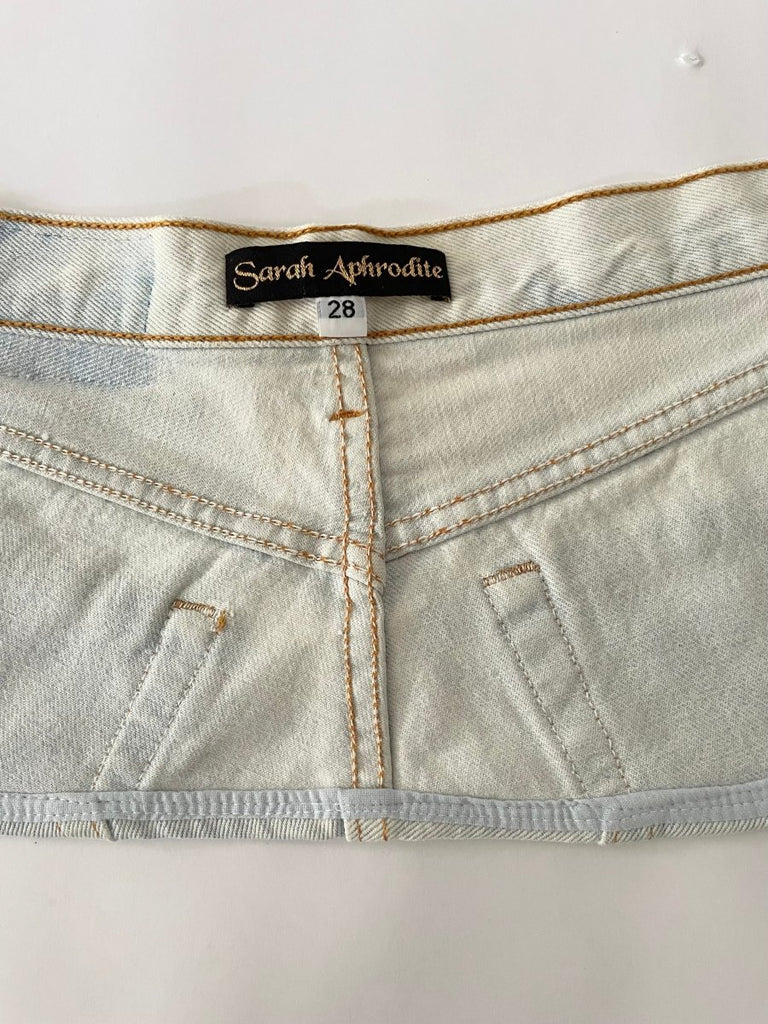 Handmade one-of-a-kind bleached denim belt by Sarah Aphrodite, size 28" waist, 7.5" wide, with hand-bleached finish, subtle painted flower mark, and original label detail on back.