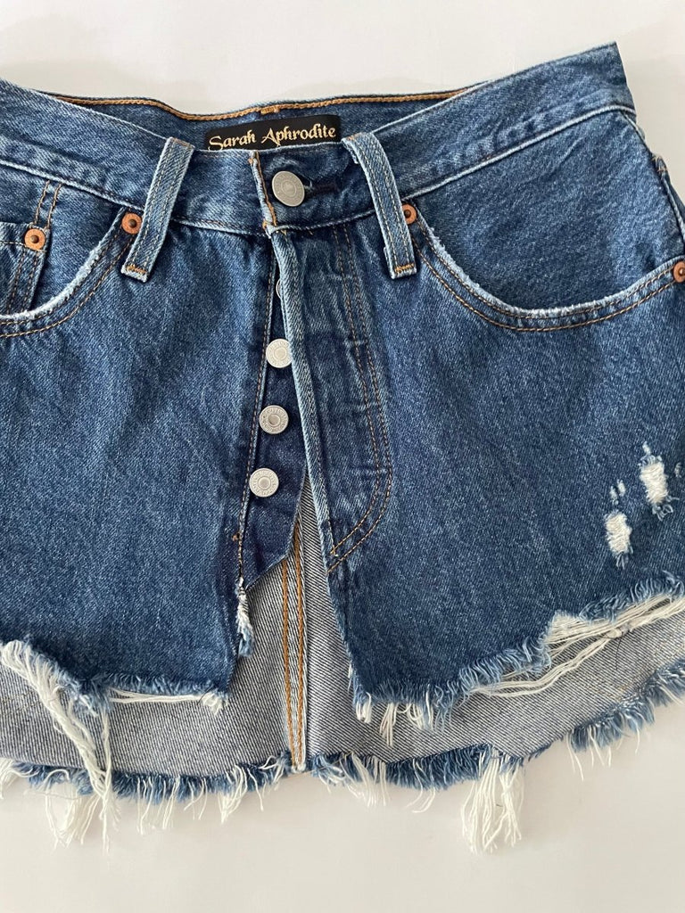 Handmade one-of-a-kind repurposed denim belt by Sarah Aphrodite, size 25" waist, fully opens with original button closure, frayed edges, heart stitching in back pockets-high-waisted design.