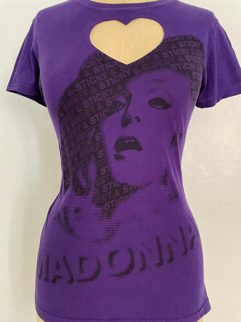 A purple t-shirt with a heart cut-out design and a printed image of a woman's face in the center.