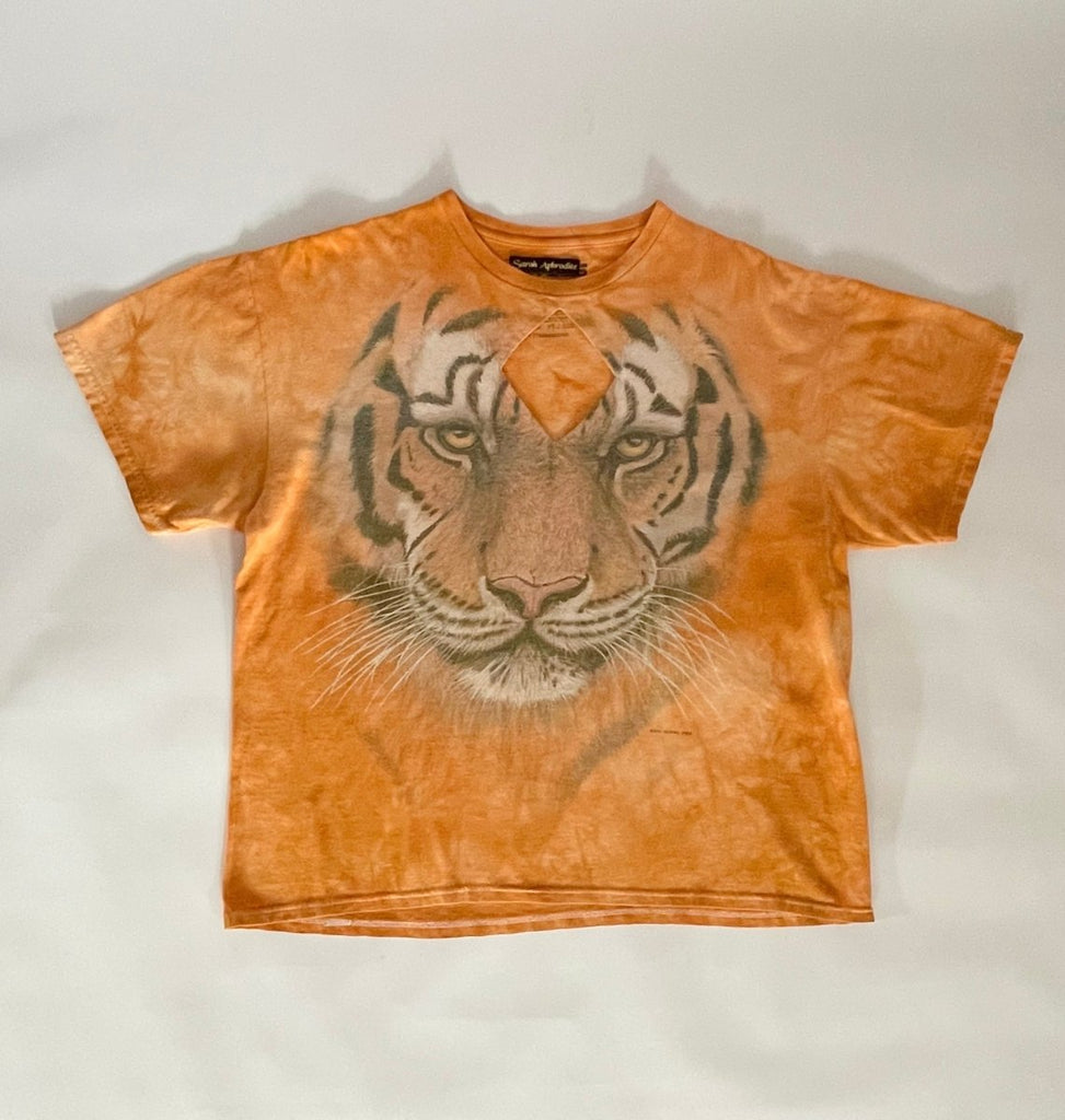 Handmade orange T-shirt with large tiger graphic and diamond-shaped chest cut-out, displayed flat on the ground