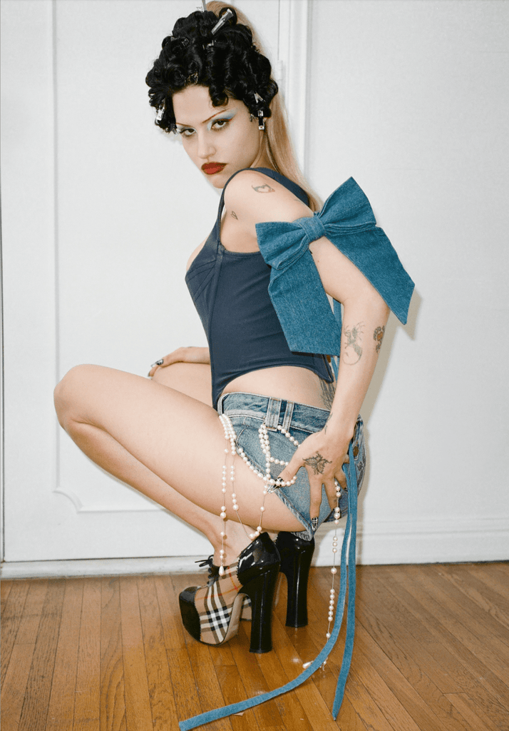 Handmade one-of-a-kind dark blue denim bow garter by Sarah Aphrodite, made from repurposed denim scraps, with long ties for versatile styling on arm, thigh, or waist.