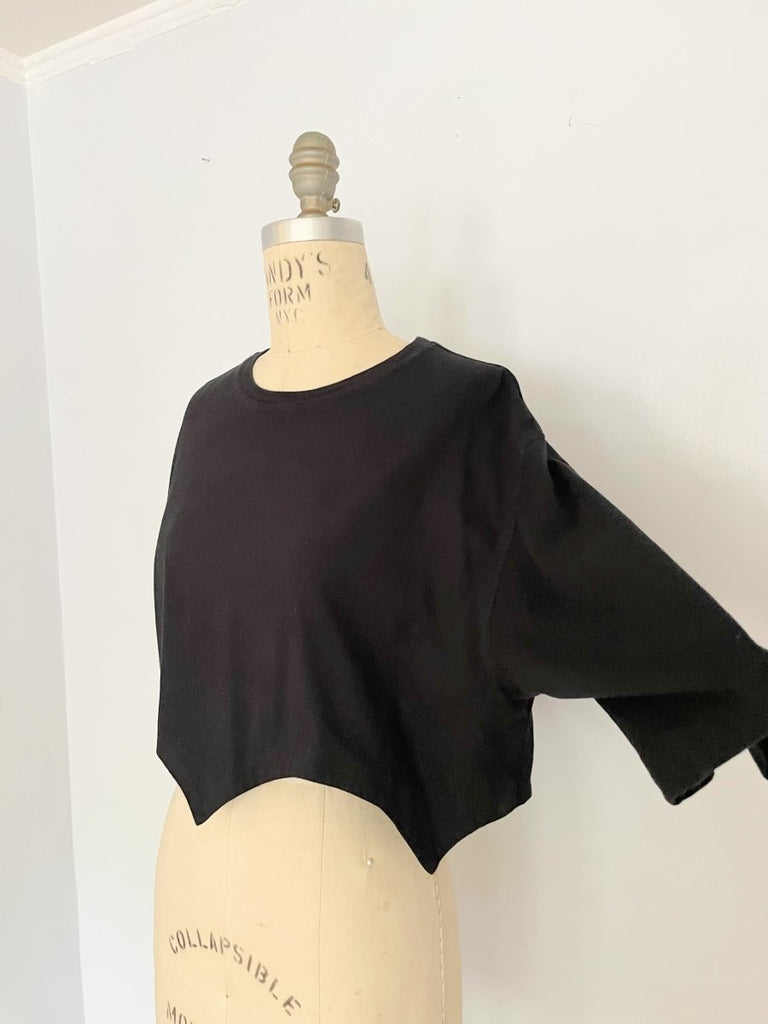 Handmade black cropped T-shirt with scallop hem, crafted from salvaged cotton. One-of-a-kind sustainable piece by Sarah Aphrodite.