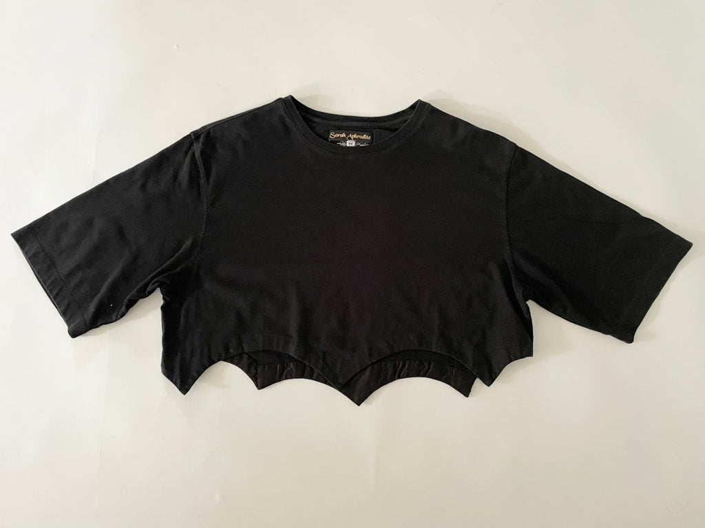 Handmade black cropped T-shirt with scallop hem, crafted from salvaged cotton. One-of-a-kind sustainable piece by Sarah Aphrodite.