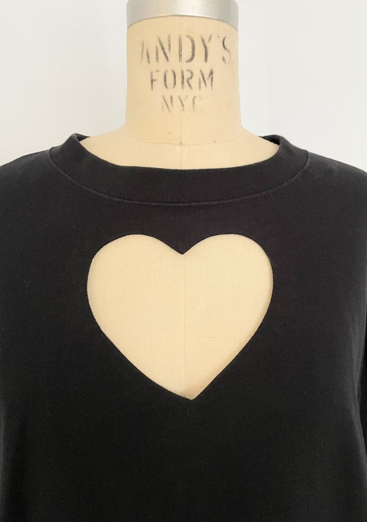 One-of-a-kind sustainable black heart cut-out sweater by Sarah Aphrodite. Handmade from repurposed fabric. Cozy, eco-conscious, and fits Medium.