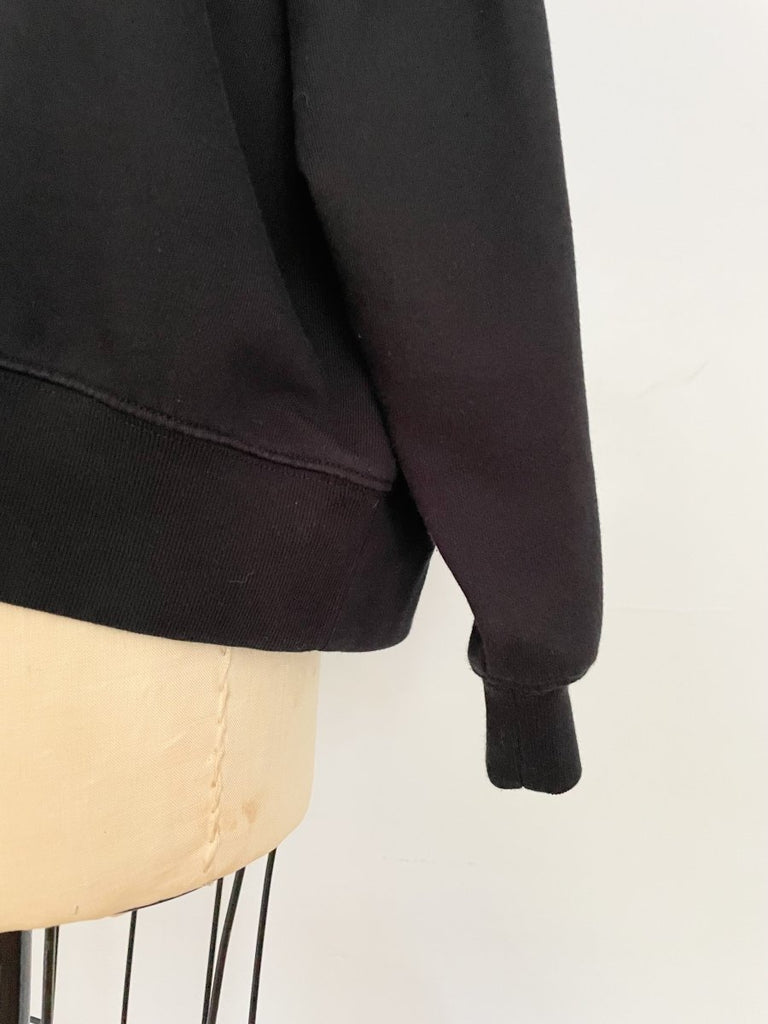 One-of-a-kind sustainable black heart cut-out sweater by Sarah Aphrodite. Handmade from repurposed fabric. Cozy, eco-conscious, and fits Medium.