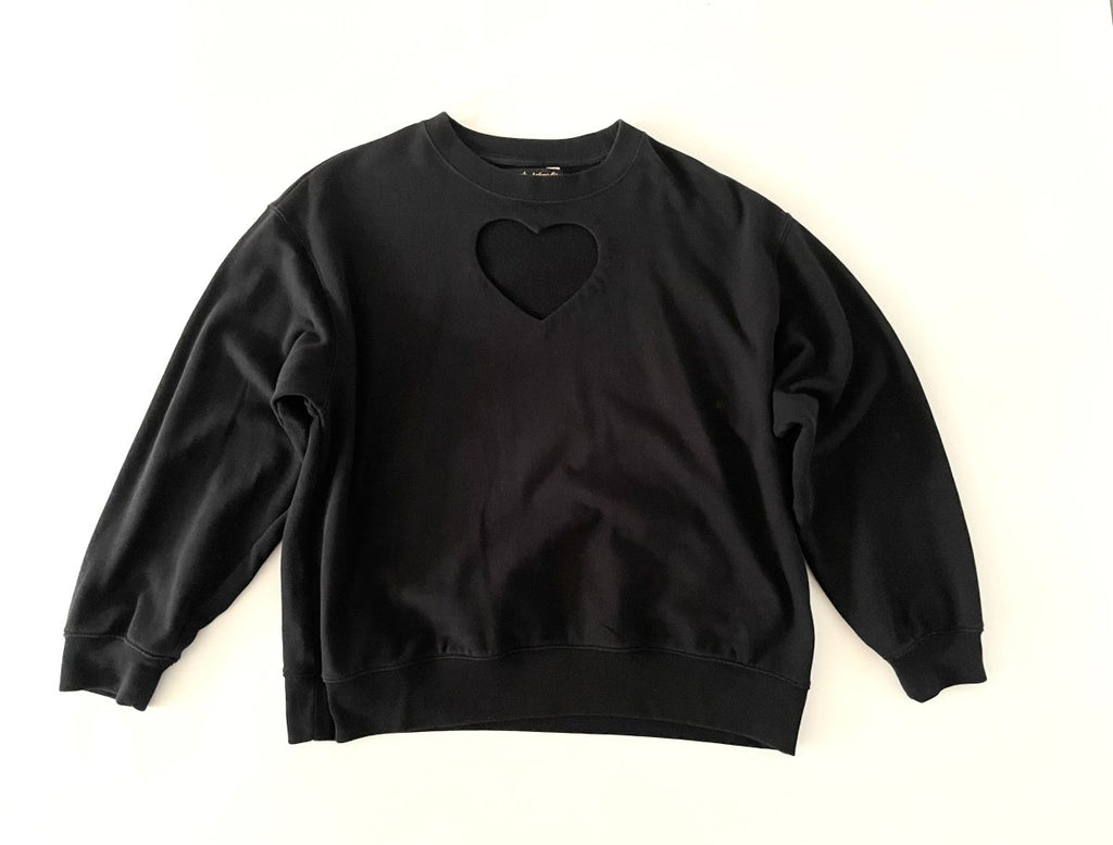 One-of-a-kind sustainable black heart cut-out sweater by Sarah Aphrodite. Handmade from repurposed fabric. Cozy, eco-conscious, and fits Medium.
