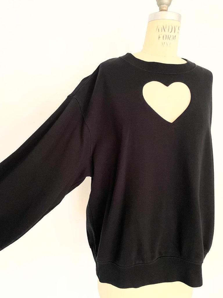 One-of-a-kind sustainable black heart cut-out sweater by Sarah Aphrodite. Handmade from repurposed fabric. Cozy, eco-conscious, and fits Medium.