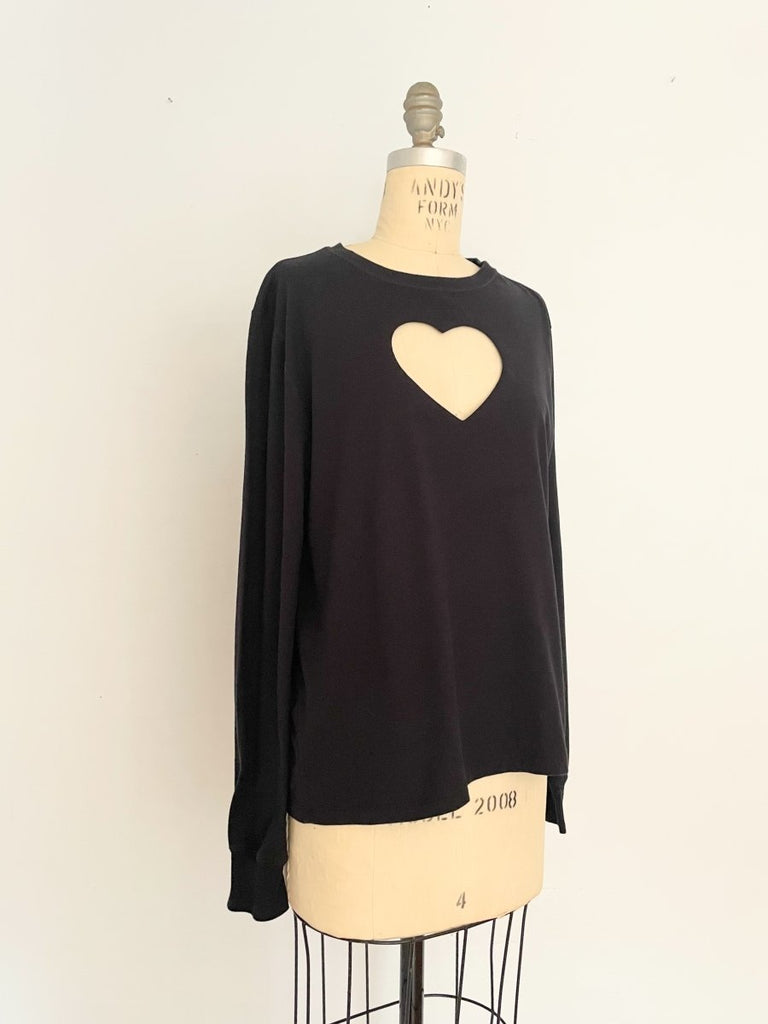 One-of-a-kind sustainable black long sleeve heart cut-out top by Sarah Aphrodite. Handmade from repurposed cotton with Champion logo on sleeve.
