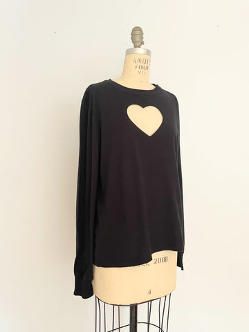 One-of-a-kind sustainable black long sleeve heart cut-out top by Sarah Aphrodite. Handmade from repurposed cotton with Champion logo on sleeve.