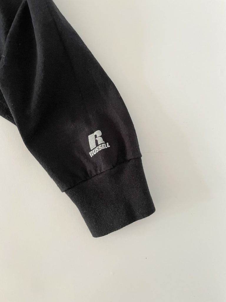 Handmade sustainable black long sleeve top with chest heart cut-out and Russell Athletic logo on sleeve. One-of-a-kind by Sarah Aphrodite. Size Medium.