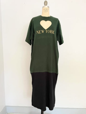 One-of-a-kind sustainable heart cut-out t-shirt dress by Sarah Aphrodite, handmade from repurposed t-shirts. Features yellow “NEW YORK” embroidery, natural fading marks, and fits Medium.
