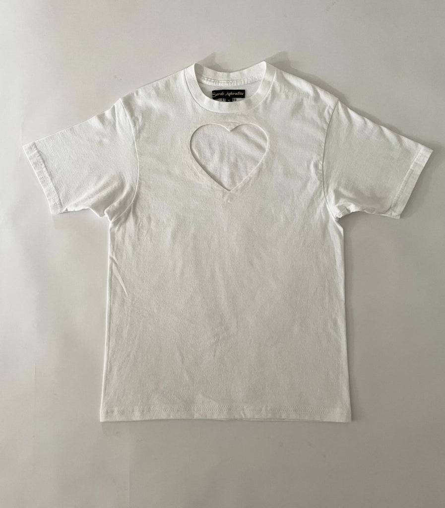 One-of-a-kind sustainable white t-shirt by Sarah Aphrodite, featuring a large heart cut-out. Handmade from repurposed fabric. Fits S–M, eco-conscious design.