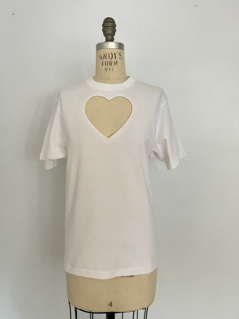 One-of-a-kind sustainable white t-shirt by Sarah Aphrodite, featuring a large heart cut-out. Handmade from repurposed fabric. Fits S–M, eco-conscious design.