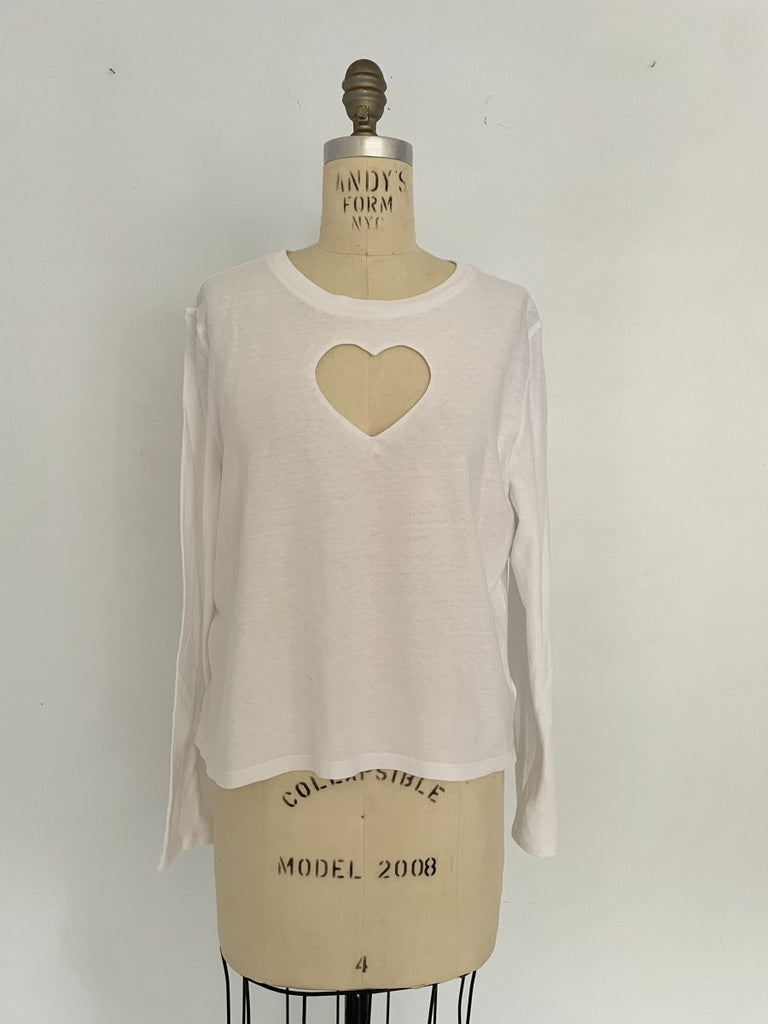 One-of-a-kind sustainable white long sleeve top by Sarah Aphrodite. Features heart cut-out on chest, handmade from repurposed cotton. Fits size Medium.