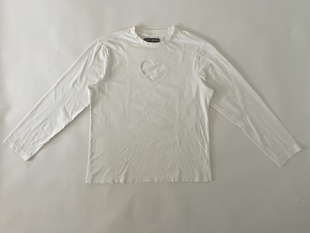 One-of-a-kind sustainable white long sleeve top by Sarah Aphrodite. Heart cut-out on chest, slightly longer length, handmade from repurposed cotton. Fits Medium.
