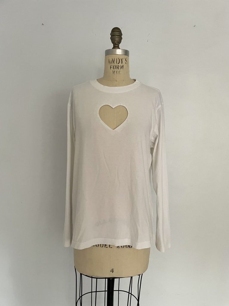 One-of-a-kind sustainable white long sleeve top by Sarah Aphrodite. Heart cut-out on chest, slightly longer length, handmade from repurposed cotton. Fits Medium.