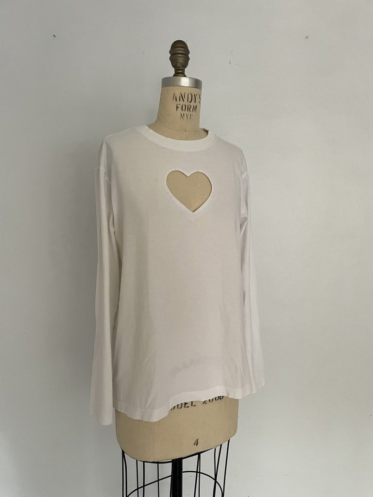 One-of-a-kind sustainable white long sleeve top by Sarah Aphrodite. Heart cut-out on chest, slightly longer length, handmade from repurposed cotton. Fits Medium.