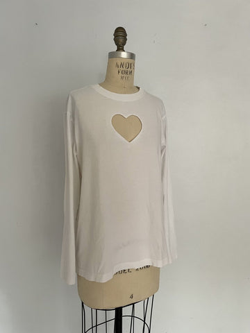 One-of-a-kind sustainable white long sleeve top by Sarah Aphrodite. Heart cut-out on chest, slightly longer length, handmade from repurposed cotton. Fits Medium.