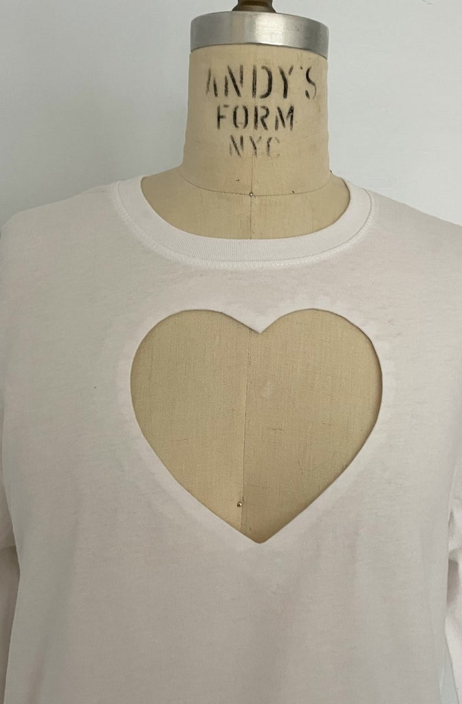One-of-a-kind sustainable white long sleeve top by Sarah Aphrodite. Large heart cut-out on chest, handmade from repurposed cotton. Fits Medium.