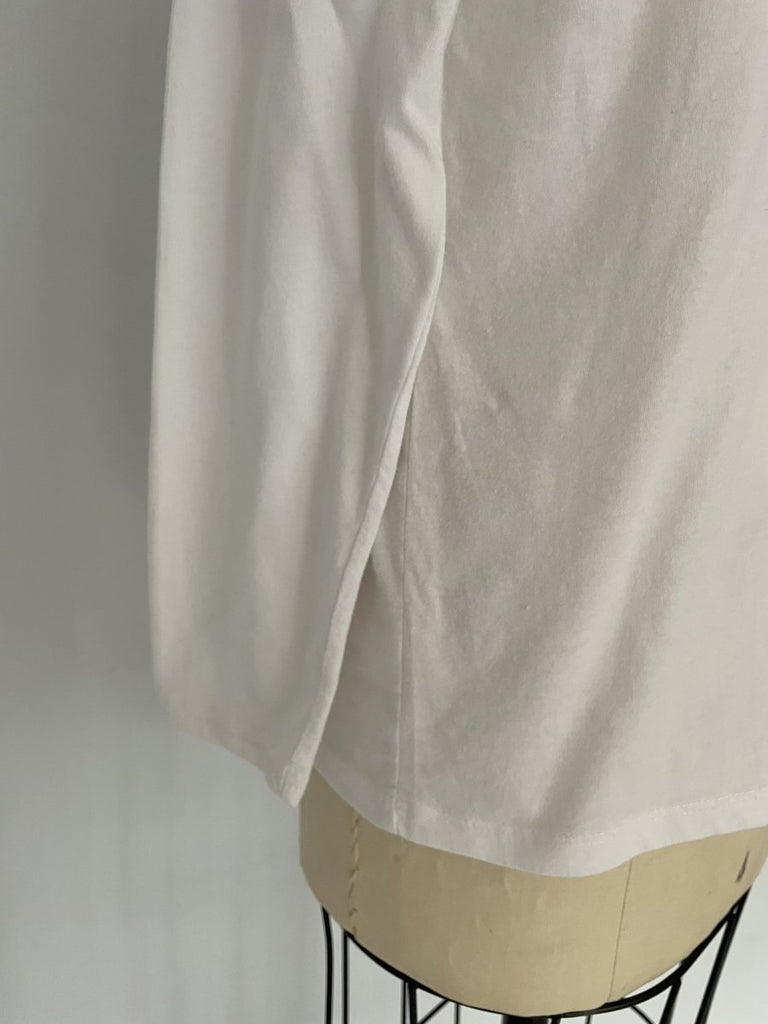 One-of-a-kind sustainable white long sleeve top by Sarah Aphrodite. Large heart cut-out on chest, handmade from repurposed cotton. Fits Medium.