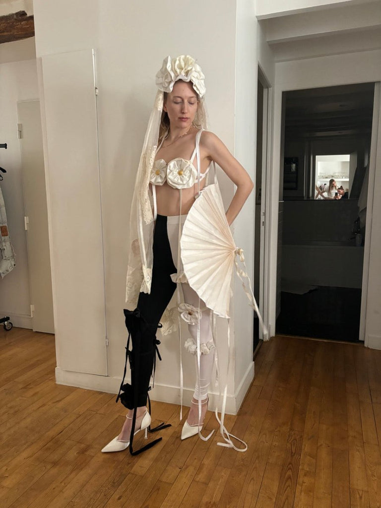 White handmade silk shantung fan accessory with polyester lining by Sarah Aphrodite, worn as an avant-garde shoulder decoration