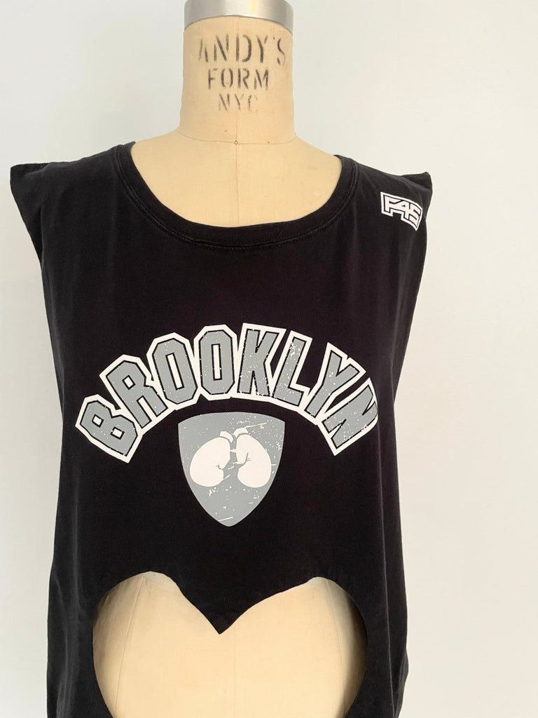 close up of front view of a sustainable handmade one-of-a-kind belly heart cut-out tank with Brooklyn print by Sarah Aphrodite displayed on a mannequin
