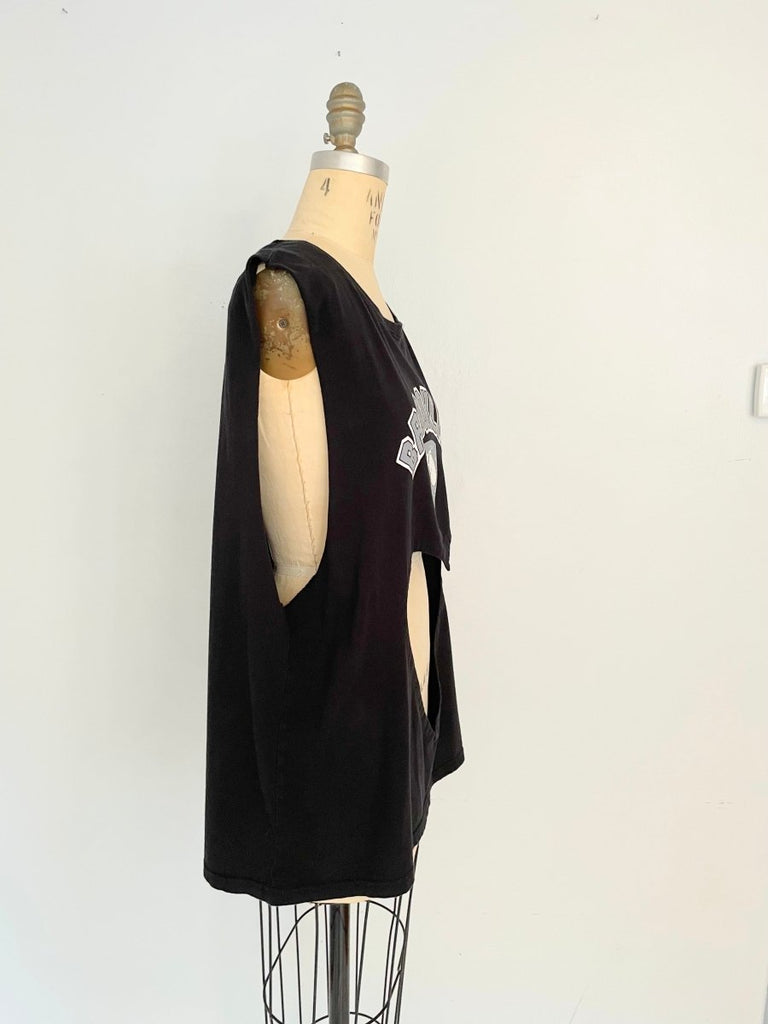 side view of a sustainable handmade one-of-a-kind belly heart cut-out tank with Brooklyn print on the front by Sarah Aphrodite displayed on a mannequin