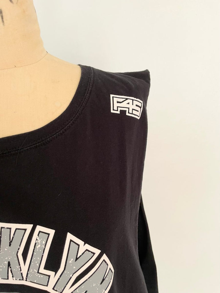 close up of F45 of a sustainable handmade one-of-a-kind belly heart cut-out tank with Brooklyn print by Sarah Aphrodite displayed on a mannequin