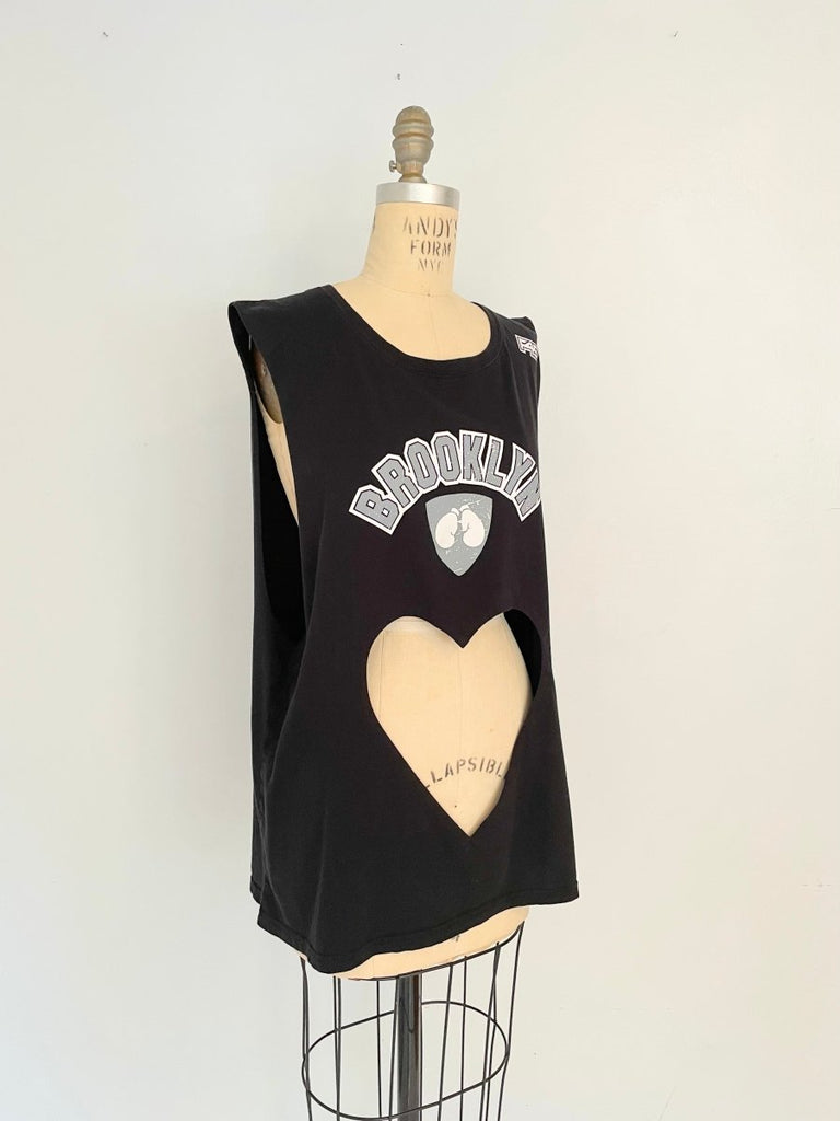 Front view of a sustainable handmade one-of-a-kind belly heart cut-out tank with Brooklyn print displayed on a mannequin