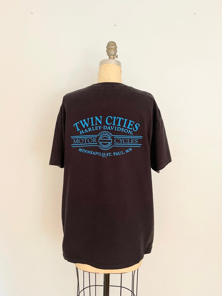 A black t-shirt with a Harley Davidson print on the back, displayed on a mannequin.