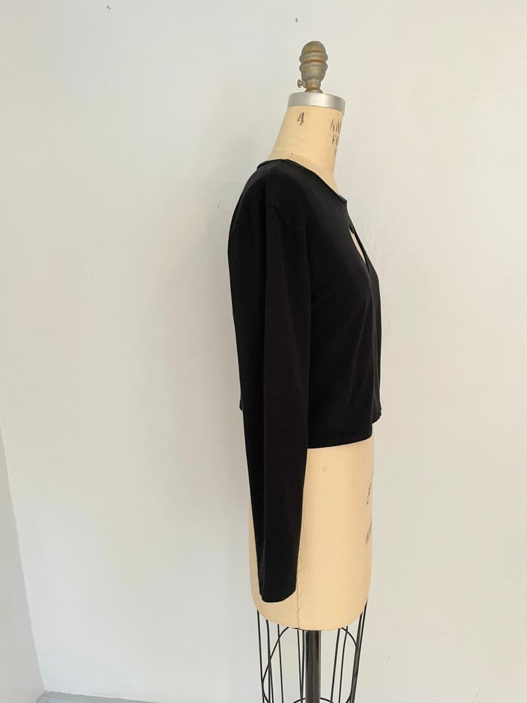 Black long sleeve cotton heart cut out displayed on a mannequin torso.
