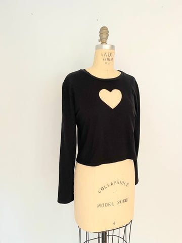 Black long sleeve cotton heart cut out tee displayed on a mannequin torso.