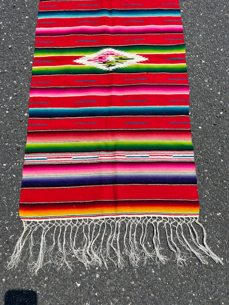 Colorful handwoven Mexican tapestry with bold traditional patterns and fringe, 46 x 117 cm
