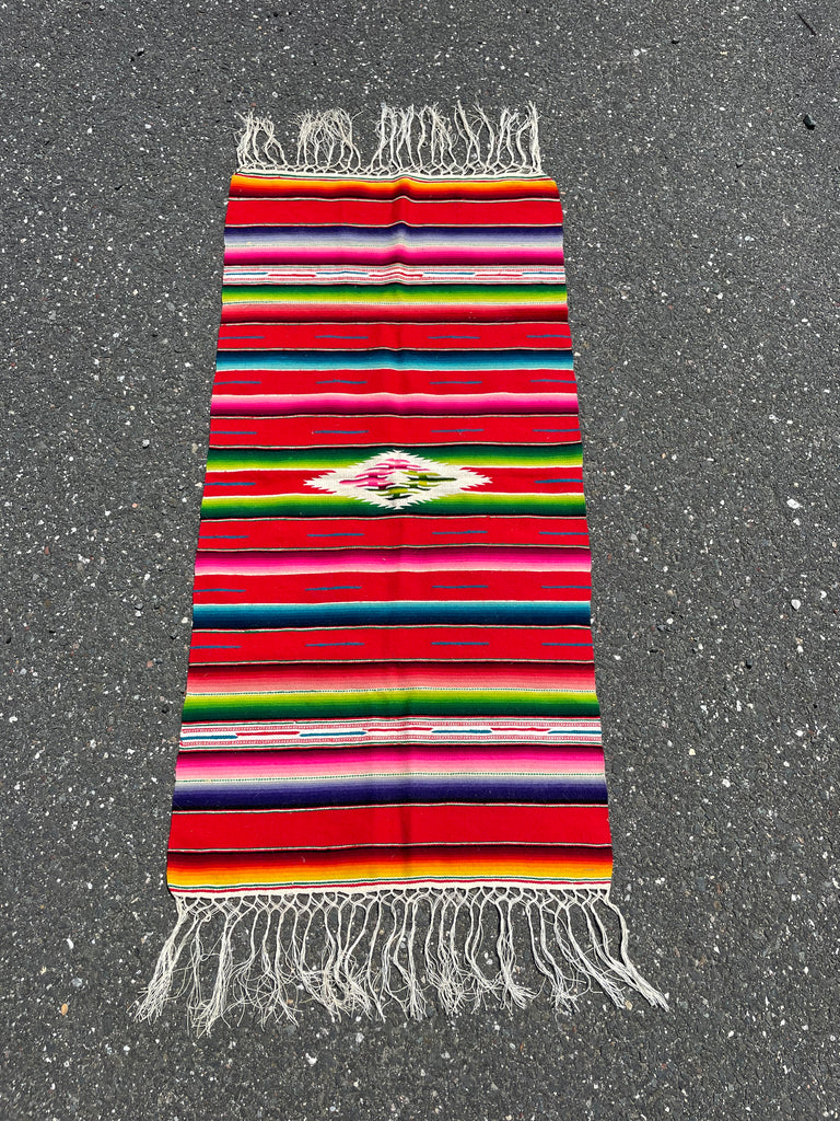 Colorful handwoven Mexican tapestry with bold traditional patterns and fringe, 46 x 117 cm
