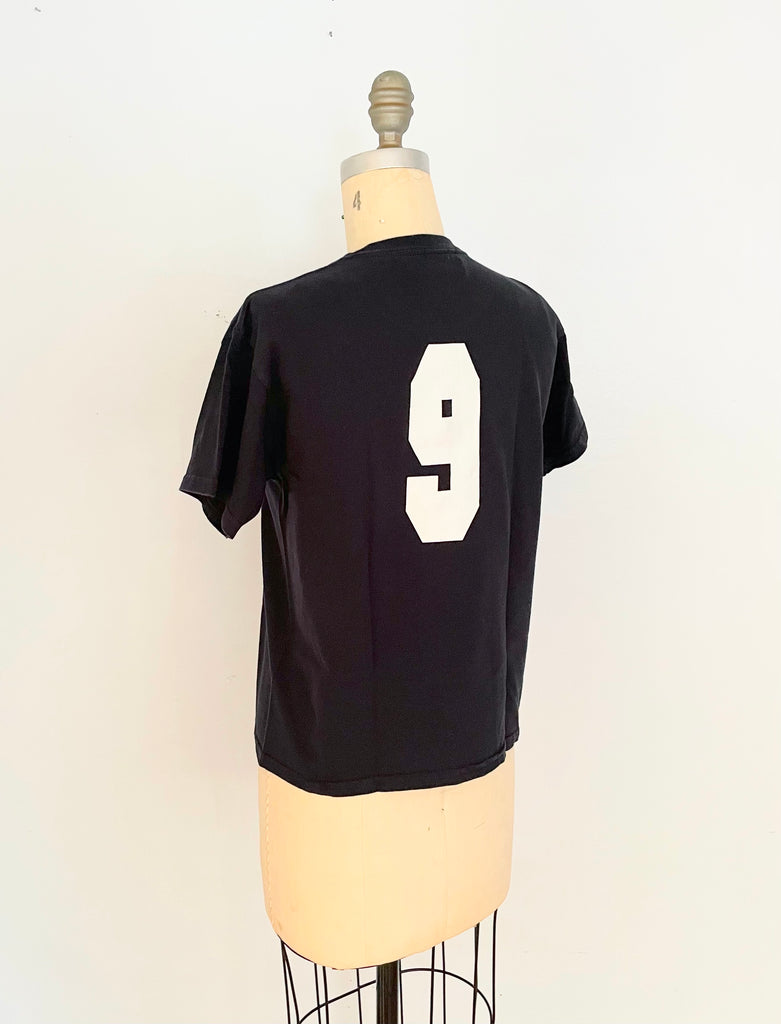 back view of handmade heart cut-out t-shirt  with a varsity '9' on the back displayed on a mannequin