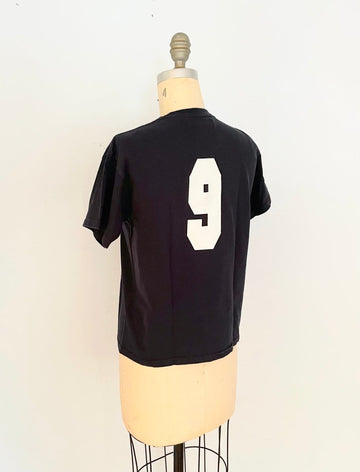 back view of handmade heart cut-out t-shirt  with a varsity '9' on the back displayed on a mannequin