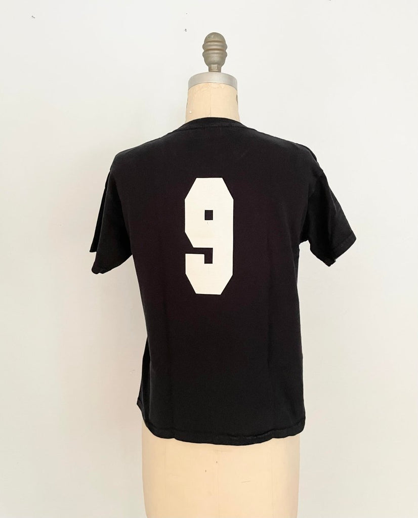 back view of handmade heart cut-out t-shirt  with a varsity '9' on the back displayed on a mannequin