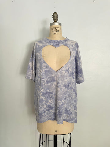 Tie-dye t-shirt with a heart cutout on a mannequin against a white background