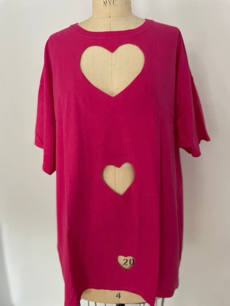 Handmade magenta pink t-shirt with 3 heart cutouts, made from recycled fabric.