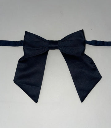 Flatlay of a one-of-a-kind navy bow accessory, 4 inches across