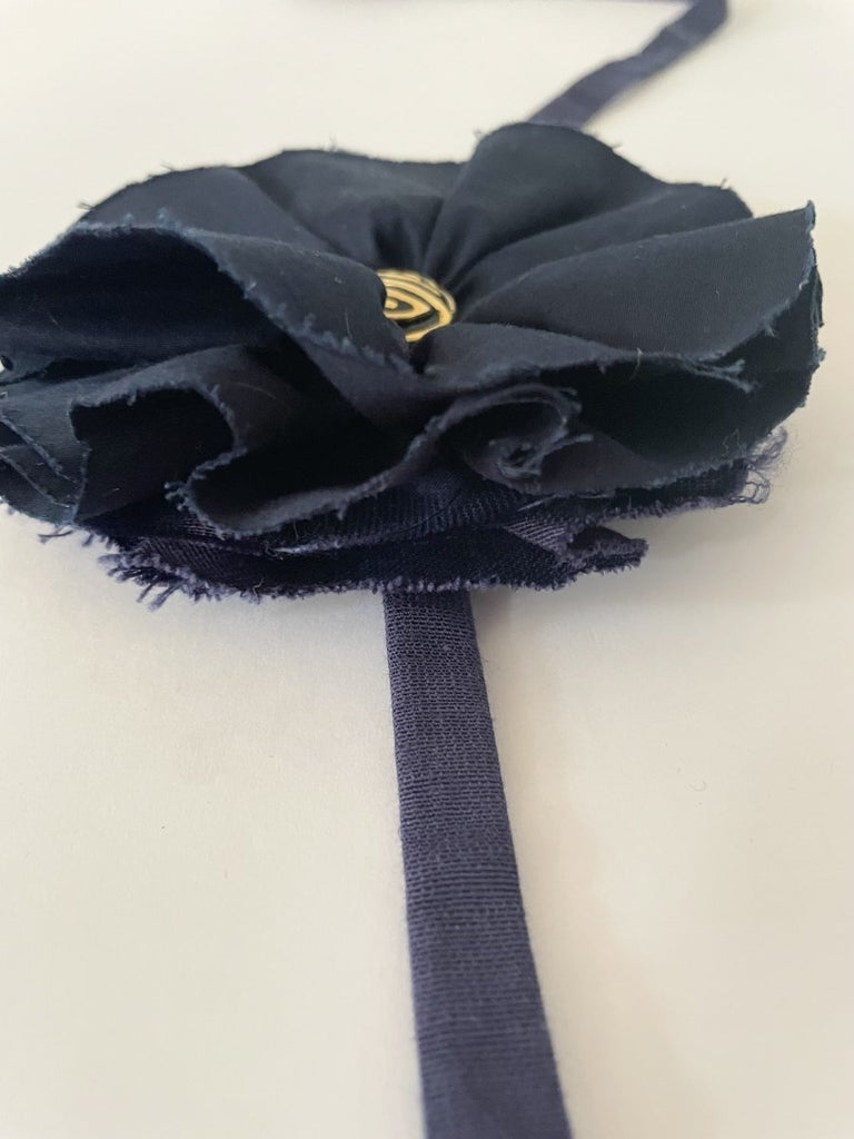 Handmade navy fabric flower accessory with ties and gold nautical button by Sarah Aphrodite. 5.5 inches wide.