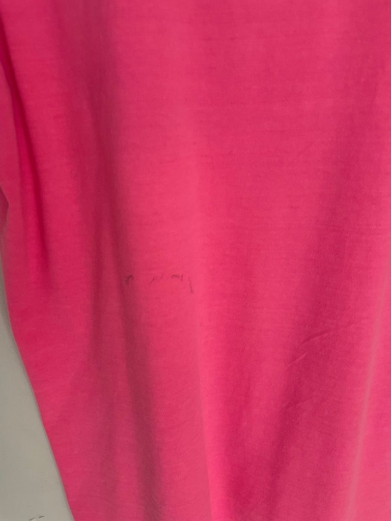 close up of a stain on a bright pink t-shirt 