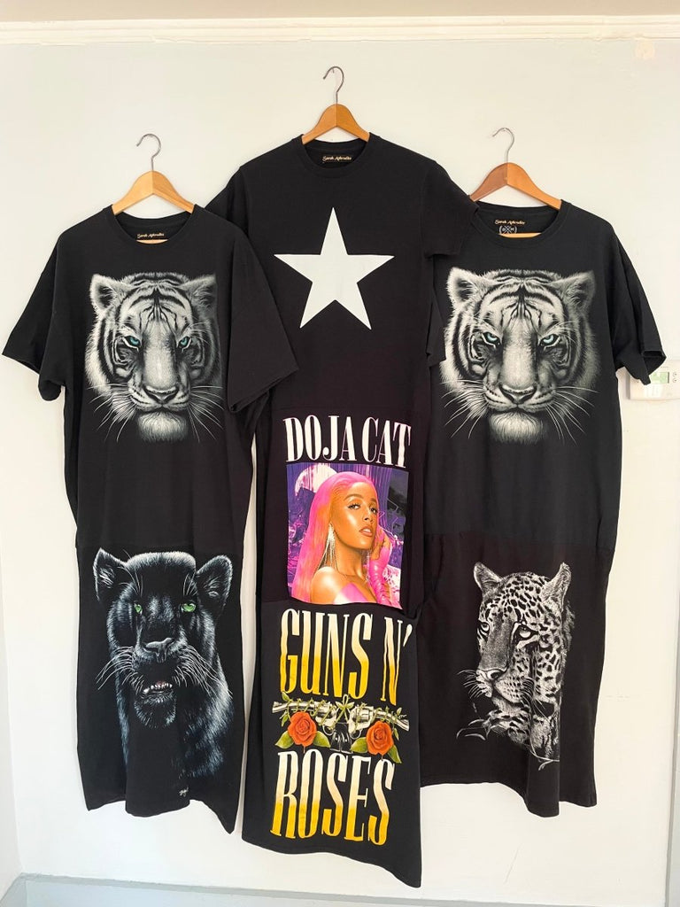 One-of-a-kind handmade T-shirt maxi dresses made from recycled cotton tees, photographed on a hanger against a white will together with 2 other maxi dresses with a cat print.