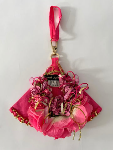 Front view of pink triangle-shaped archival bag with handmade Mexican flowers