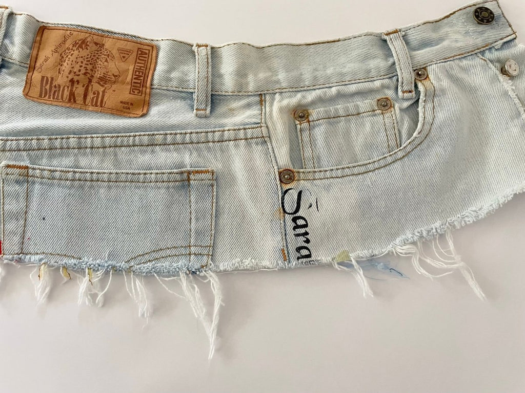 Recycled bleached denim belt with black silkscreen print, frayed edge, rustic hardware, and original label – size 28 waist

