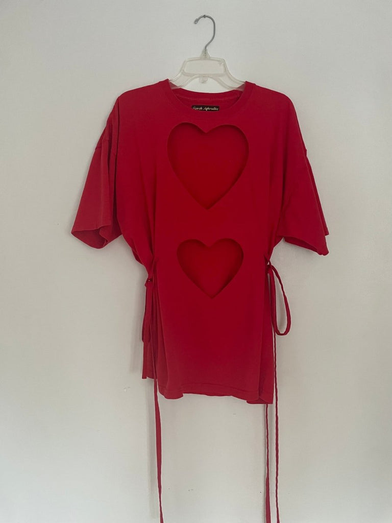 front view of one-of-a-kind red double heart cut-out t-shirt with ties on a hanger